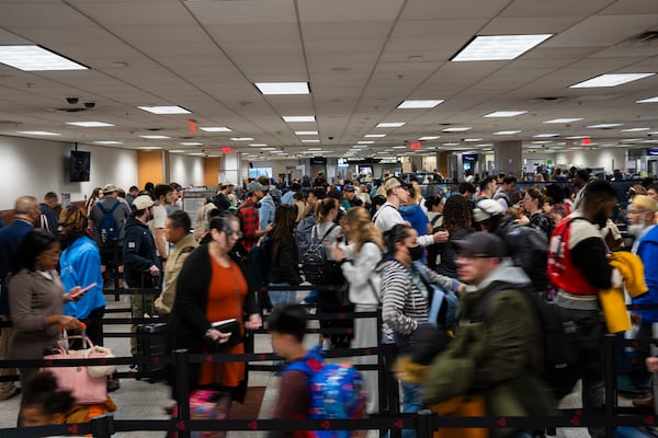 Travelers rush to their gate at Hartsfield-Jackson Atlanta International Airport, Tuesday, Nov. 26, 2024, in Atlanta. (AP Photo/Olivia Bowdoin)