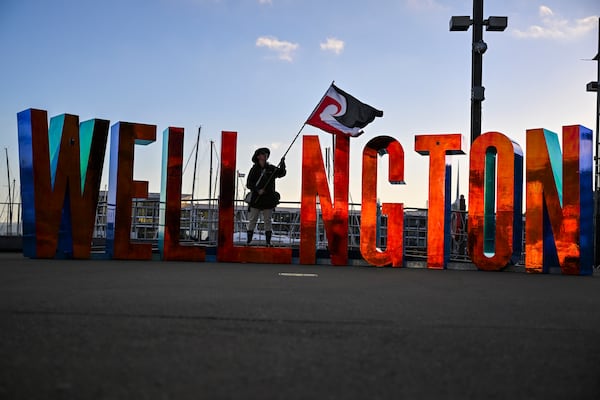 Indigenous Māori protester, Jordan Tibble, waves a sovereignty flag as he prepares to march to Parliament in Wellington, New Zealand, Tuesday, Nov. 19, 2024. (AP Photo/Mark Tantrum)