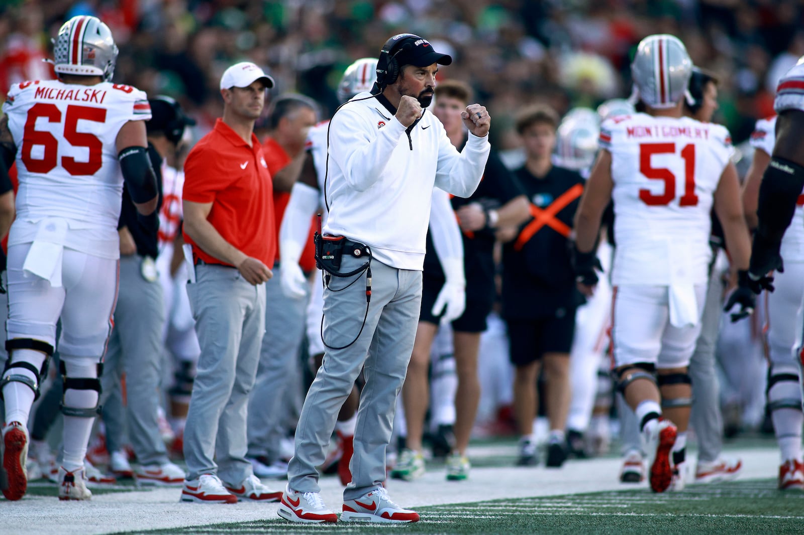 Ohio State head coach Ryan Day, center, gestures to his team during an NCAA college football game against Oregon, Saturday, Oct. 12, 2024, in Eugene, Ore. (AP Photo/Lydia Ely)