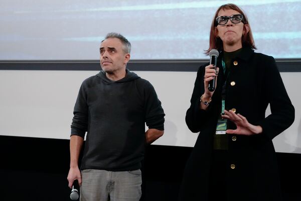 Director Joel Souza, left, and cinematographer Bianca Cline, right, attend the premiere of the film 'Rust' during the 32nd Camerimage International Film Festival in Torun, Poland, Wednesday, Nov. 20, 2024. (AP Photo/Czarek Sokolowski)