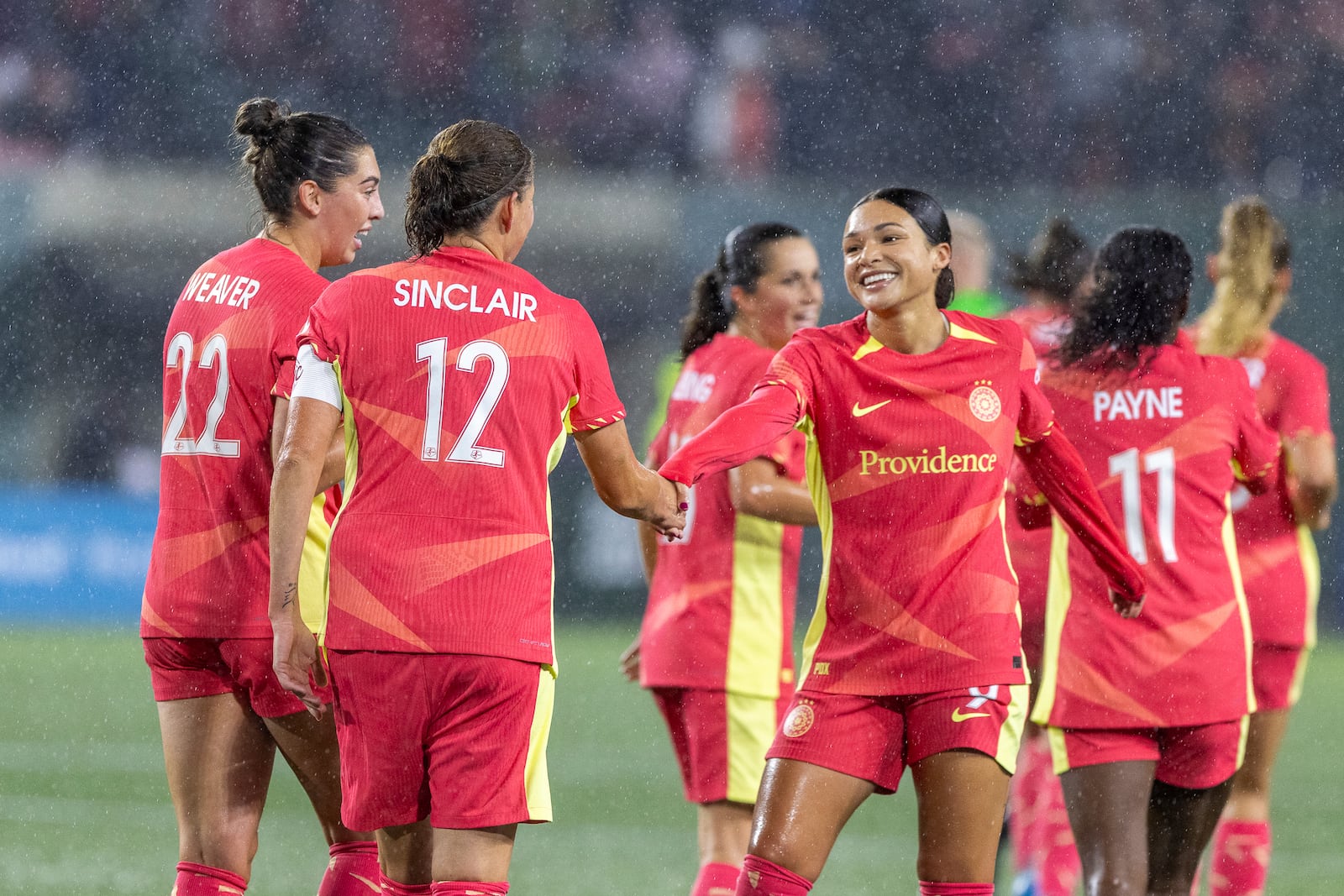 Portland Thorns forward Christine Sinclair (12) shakes the hand of forward Sophia Smith after Smith's goalduring the first half of an NWSL soccer match against Angel City FC at Providence Park on Friday Nov. 1, 2024 in Portland, Ore. (Sean Meagher/The Oregonian via AP)