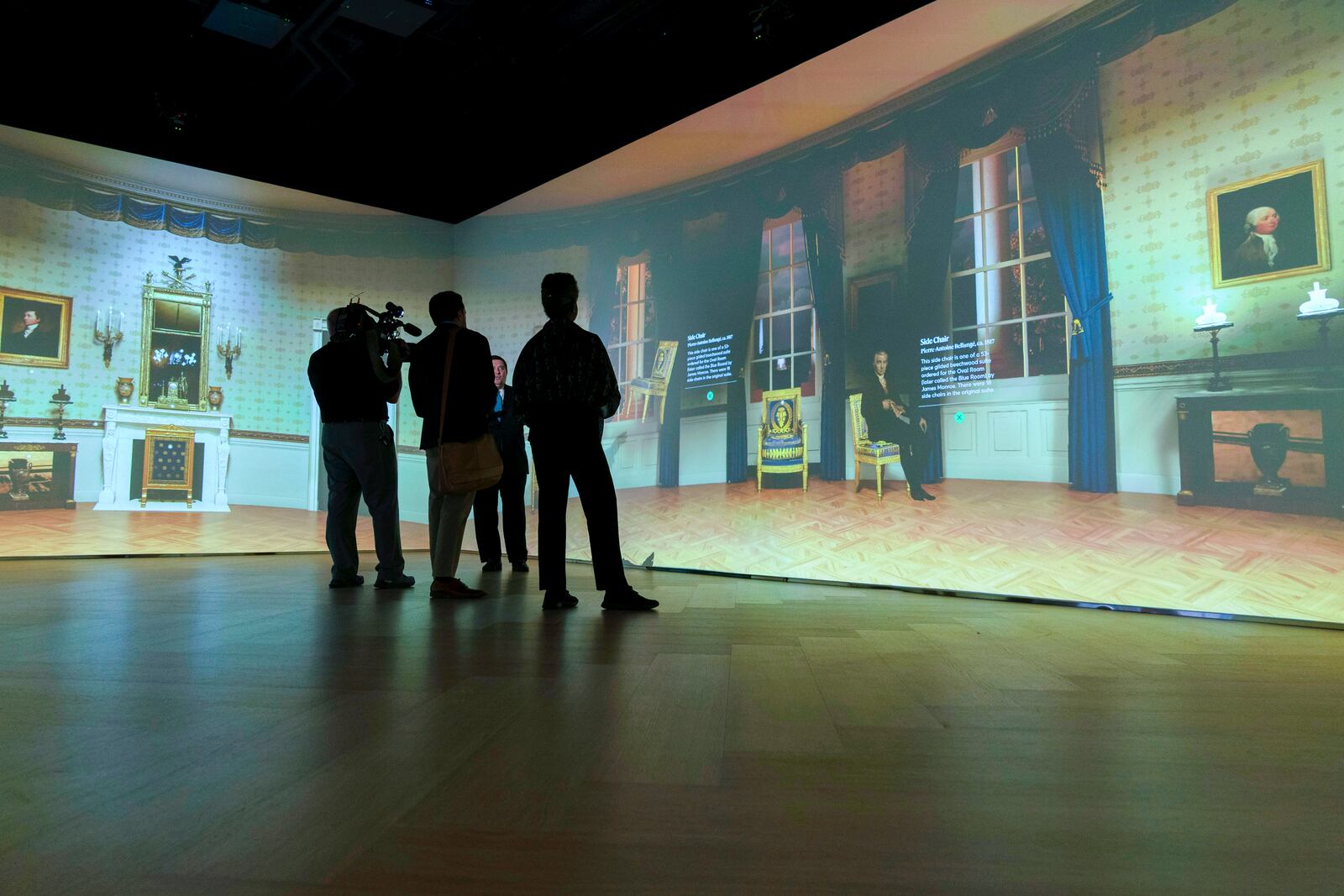 White House Historical Association President Stewart McLaurin tour members of the media in an interactive 3D room of the White House Blue Room as is today, shown at The People's House exhibit, Monday, Sept. 16, 2024 in Washington. (AP Photo/Jose Luis Magana)