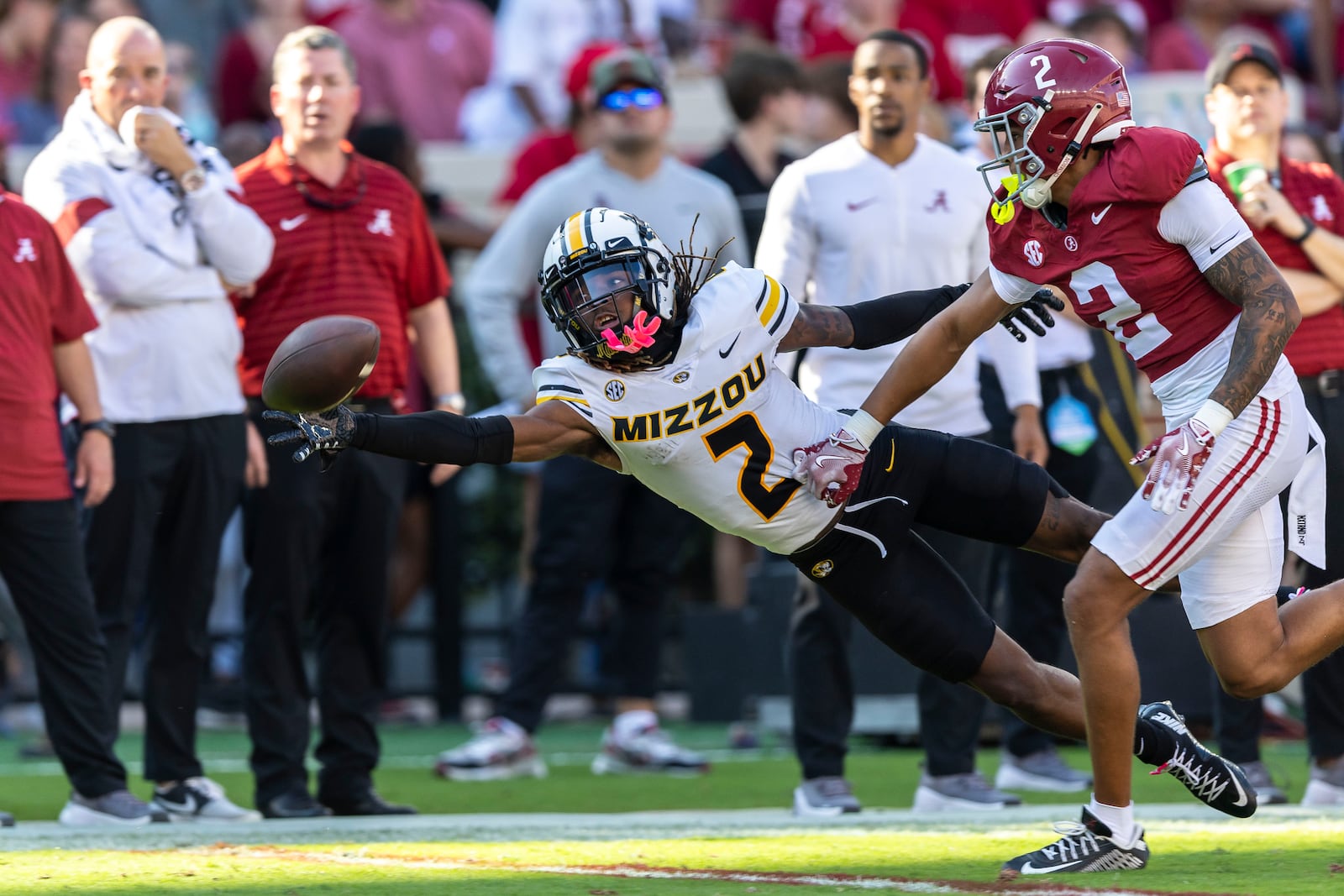 Missouri wide receiver Marquis Johnson, front left, misses a pass with Alabama defensive back Zabien Brown, front right, defending during the first half of an NCAA college football game, Saturday, Oct. 26, 2024, in Tuscaloosa, Ala. (AP Photo/Vasha Hunt)