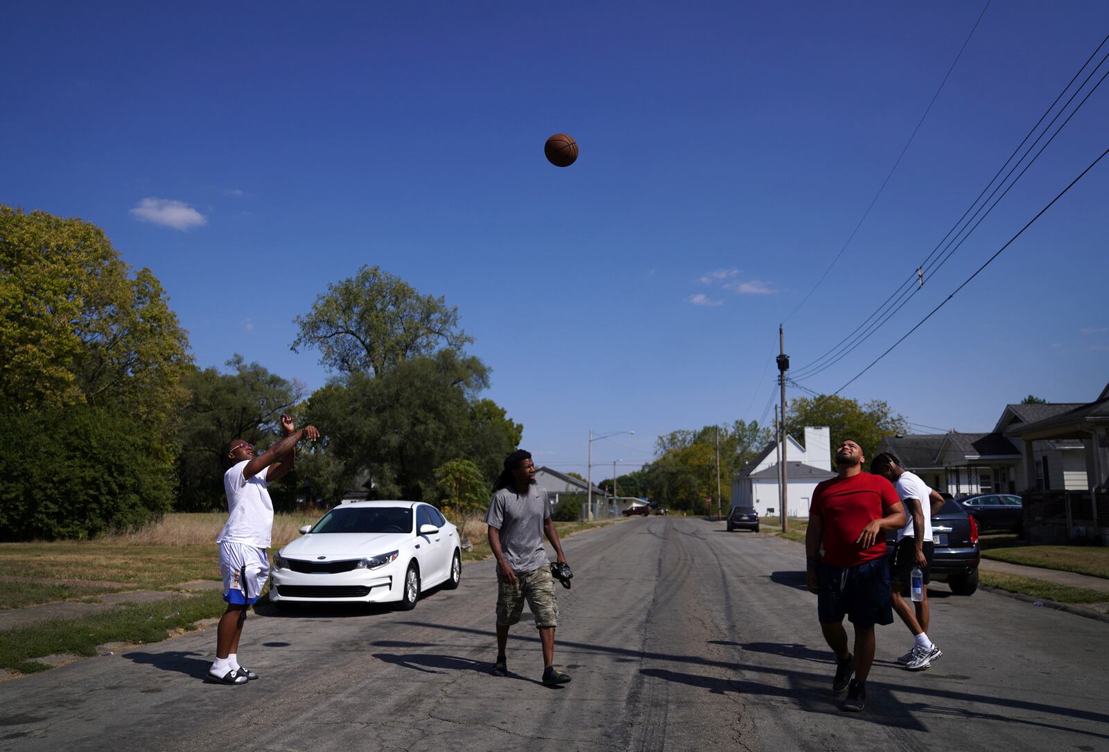 Springfield native Jaheim Almon, left, plays basketball with a group of neighbors in Springfield, Ohio, Monday, Sept. 16, 2024. (AP Photo/Jessie Wardarski)