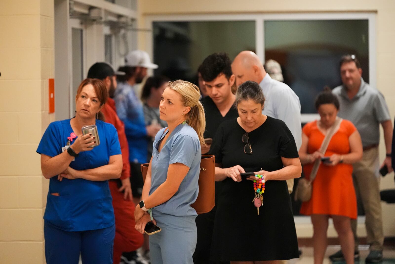 Voters wait for the polls to open at the Hynes Charter School in New Orleans on Election Day, Tuesday, Nov. 5, 2024. (AP Photo/Gerald Herbert)