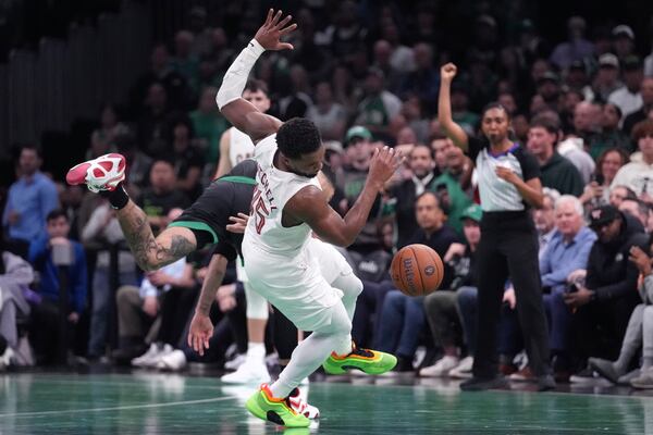 Boston Celtics forward Jayson Tatum, rear, collides with Cleveland Cavaliers guard Donovan Mitchell during the second half of an Emirates NBA Cup basketball game, Tuesday, Nov. 19, 2024, in Boston. (AP Photo/Charles Krupa)