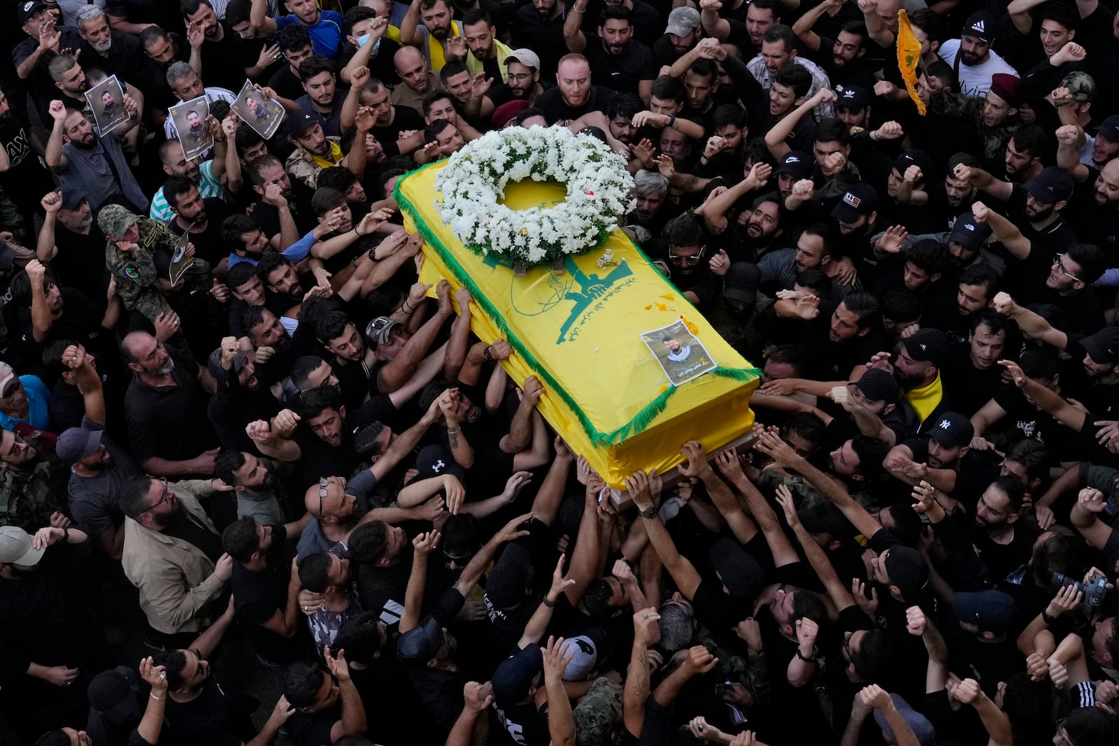 Hezbollah members carry the coffin of their comrade who was killed on Wednesday when a handheld device exploded, during a funeral procession in the southern suburbs of Beirut, Thursday, Sept. 19, 2024. (AP Photo/Hussein Malla)