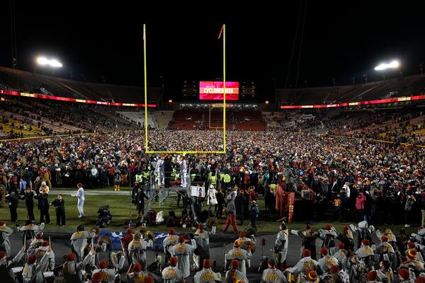 Fans celebrate on the field after an NCAA college football game between Iowa State and Kansas State, Saturday, Nov. 30, 2024, in Ames, Iowa. (AP Photo/Charlie Neibergall)