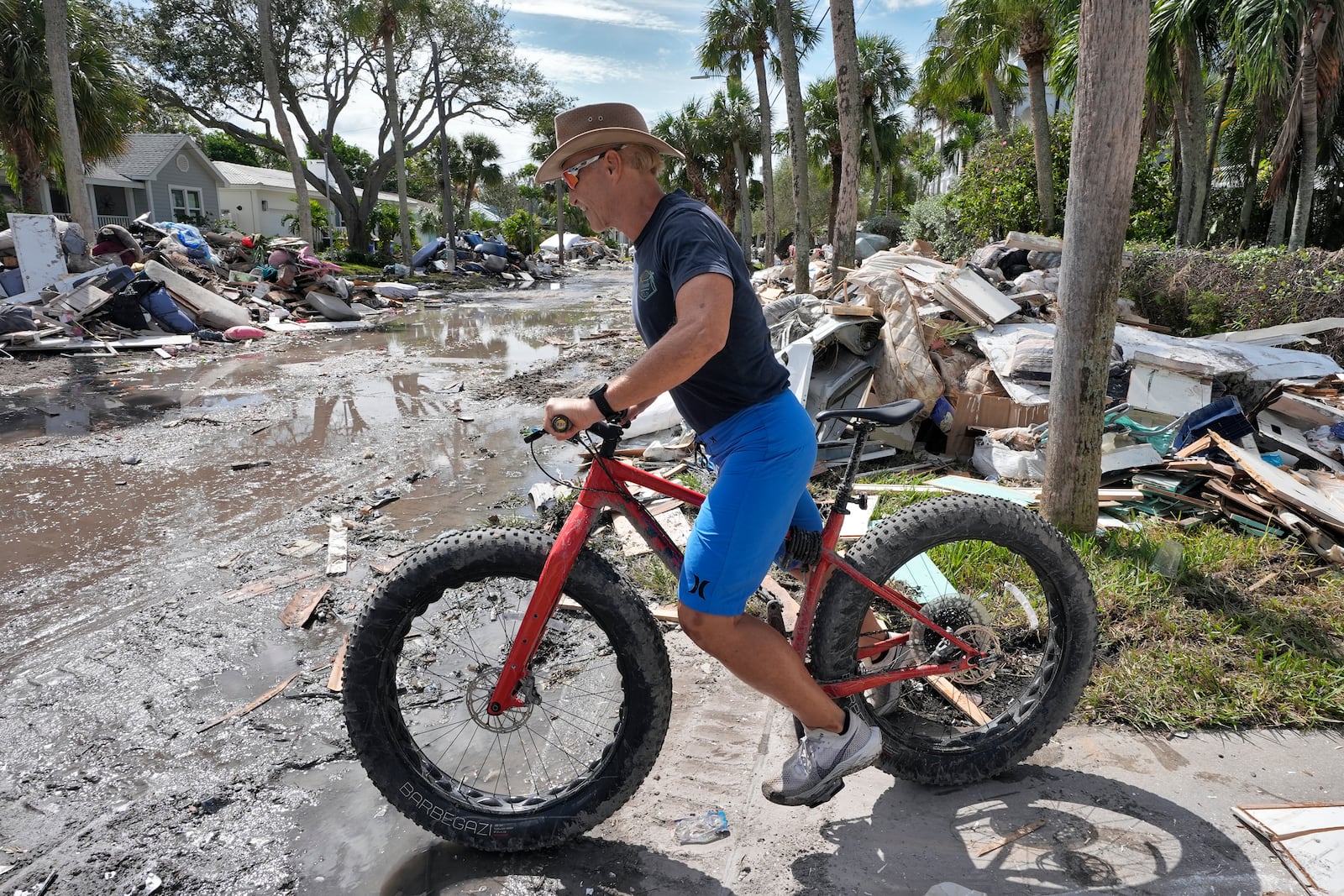 Arnie Bellini surveys the damages caused from Hurricane Helene on a street in Clearwater Beach, Fla., Tuesday, Oct. 8, 2024. Bellini fronted $500,000. of his own money to help speed up debris cleanup ahead of the possible arrival of Hurricane Milton. (AP Photo/Chris O'Meara)