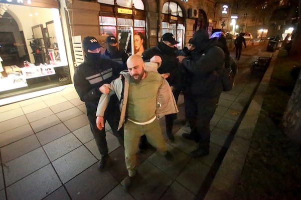 Police detain a protester outside the parliament building in Tbilisi, Georgia, on Friday, Nov. 29, 2024. (AP Photo/Zurab Tsertsvadze)