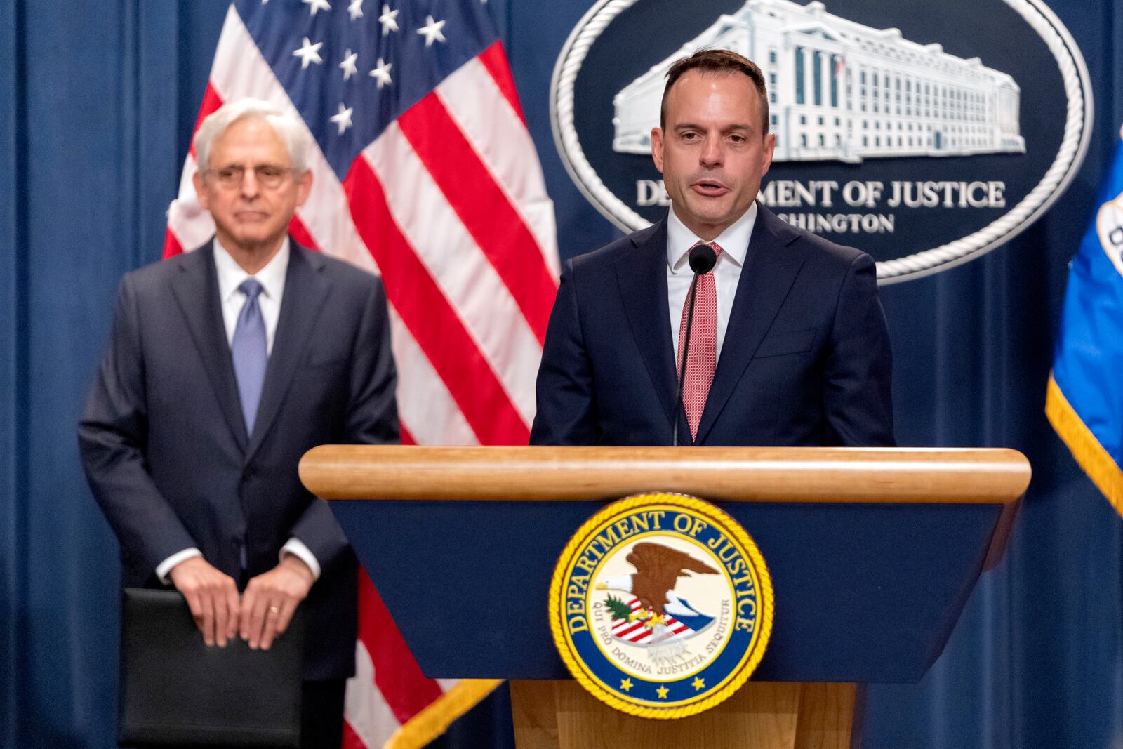 Principal Deputy Associate Attorney General Benjamin Mizer, is flanked by Attorney General Merrick Garland, left, as he speaks during a news conference at the Department of Justice, Tuesday, Sept. 24, 2024, in Washington. (AP Photo/Mark Schiefelbein)