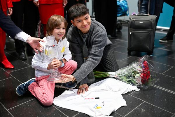 JJ, right, from Austria arrives at the airport in Vienna, Austria, Sunday, May 18, 2025, after winning the Grand Final of the 69th Eurovision Song Contest, in Basel yesterday. (AP Photo/Denes Erdos)