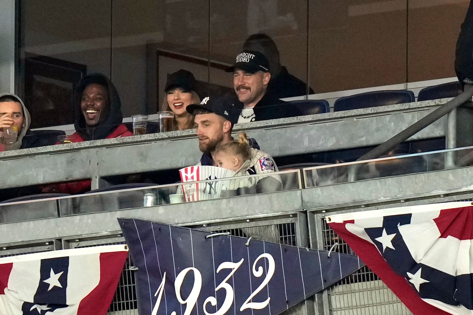 Travis Kelce, top right, and Taylor Swift watch Game 1 of the baseball AL Championship Series between the Cleveland Guardians and New York Yankees Monday, Oct. 14, 2024, in New York. (AP Photo/Frank Franklin II)