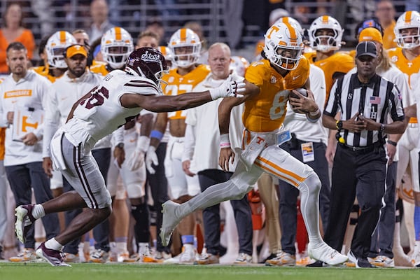 Tennessee quarterback Nico Iamaleava (8) runs for yardage while pursued by Mississippi State defensive lineman Joseph Head Jr. (46) during the first half of an NCAA college football game Saturday, Nov. 9, 2024, in Knoxville, Tenn. (AP Photo/Wade Payne)