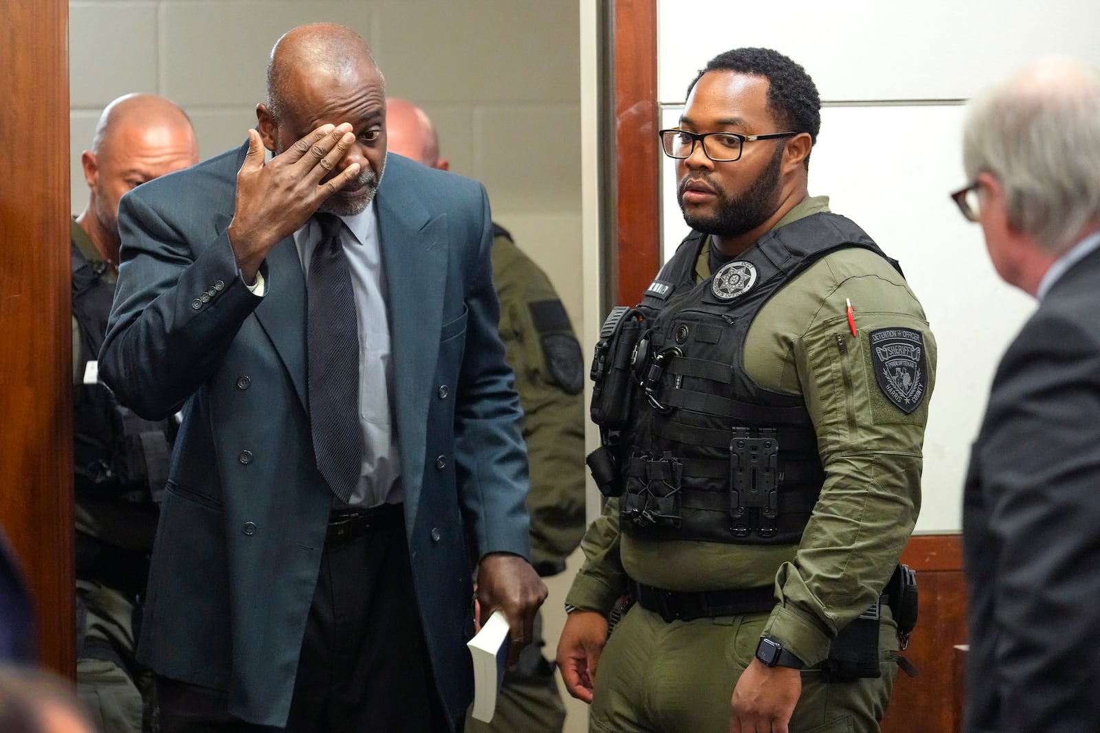 Former Houston police officer Gerald Goines is led back into the courtroom to be formally sentenced on a pair of felony murder convictions on Tuesday, Oct. 8, 2024, in Houston. Goines was found guilty of felony murder and sentenced to 60 years behind bars in the 2019 deaths of Dennis Tuttle and Rhogena Nicholas. (Brett Coomer/Houston Chronicle via AP)