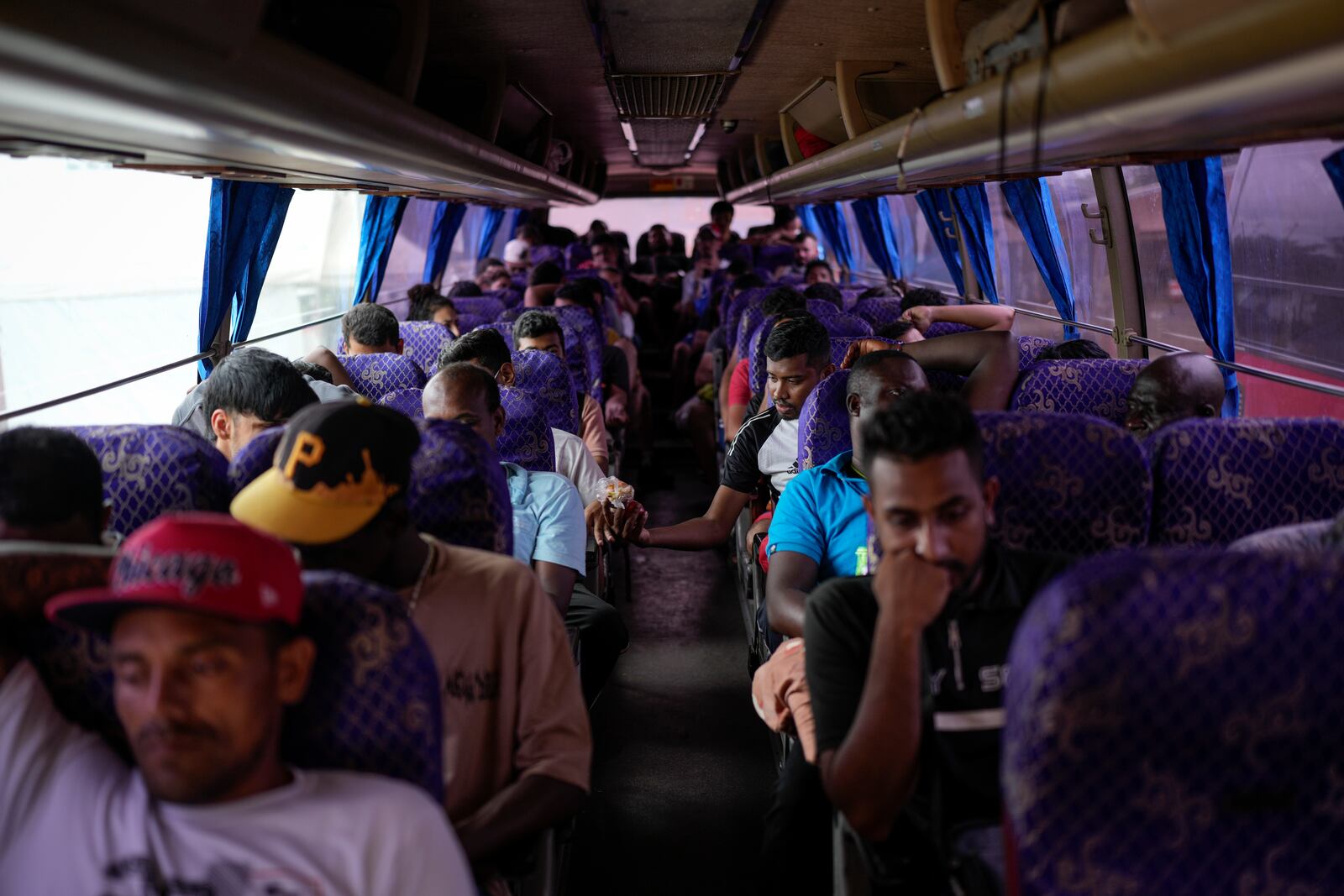 Migrants sit on a northbound bus heading to Costa Rica as they wait to leave Lajas Blancas, Panama, Thursday, Sept. 26, 2024, after walking across the Darien Gap from Colombia in hopes of reaching the U.S. (AP Photo/Matias Delacroix)