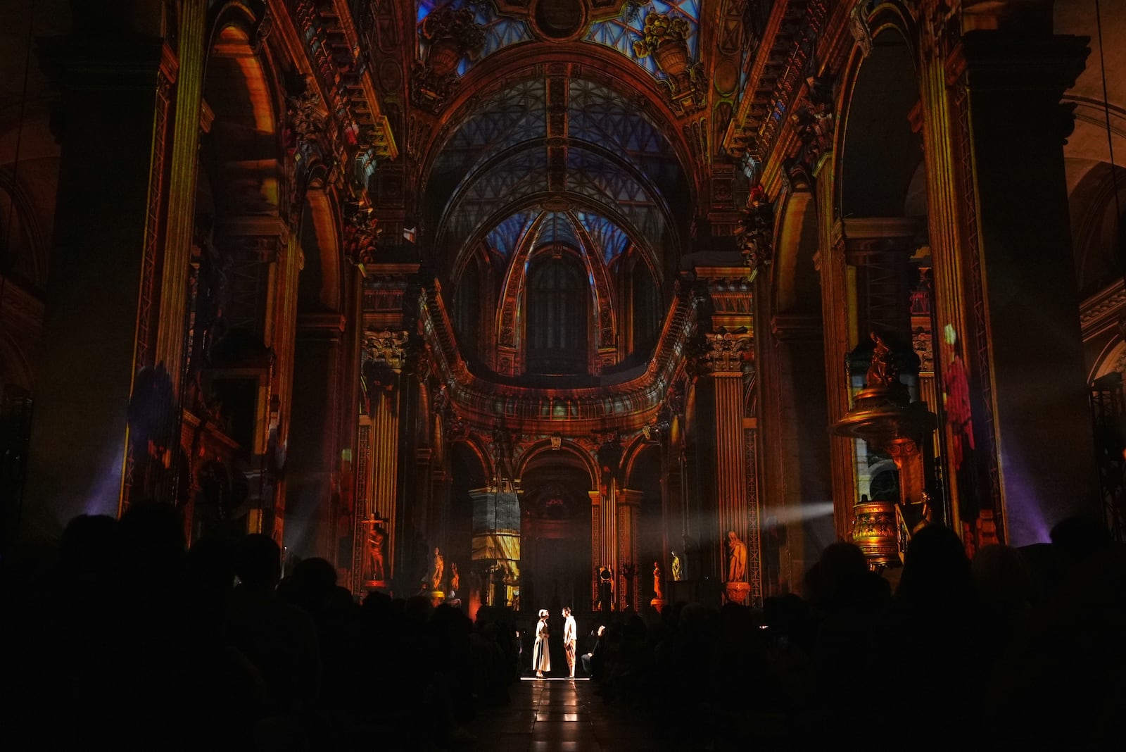 Actors and video projections are seen Thursday Oct.31, 2024 at the Saint-Sulpice church in Paris. (AP Photo/Marine Lesprit)