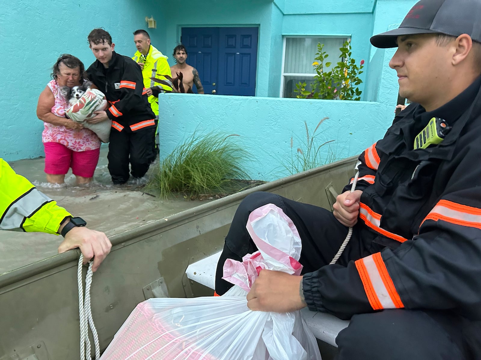 This photo provided by Venice Police Department rescue crews assist residents after conducting door-to-door wellness checks, in coastal areas that were flooded by Hurricane Helene on Friday, Sept. 27, 2024 in Venice, Fla . (Venice Police Department via AP)