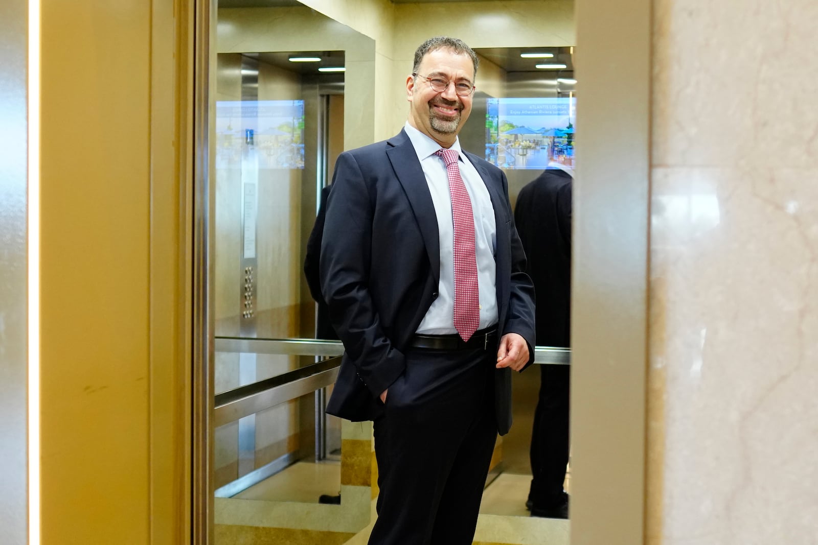 Economist Daron Acemoglu, 2024 Nobel prize winner in Economics, stands in an elevator after speaking to the media during a conference in Athens, Greece, Monday, Oct. 14, 2024. (AP Photo/Petros Giannakouris)