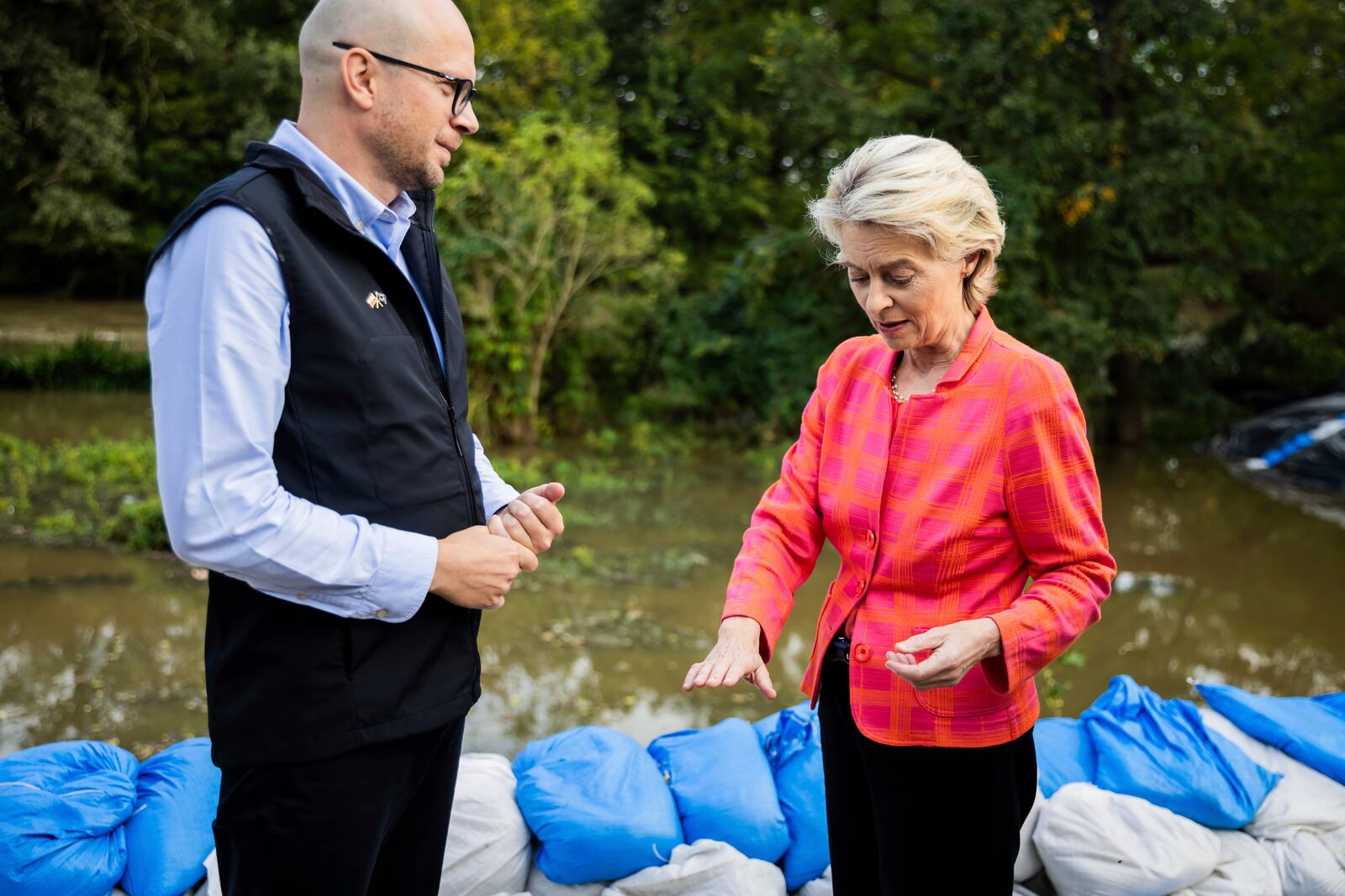 European Commmission President Ursula von der Leyen, right, talks to Jakub Mazur, First Deputy Mayor of Wroclaw, next to the river Bystrzyca near Woclaw, Poland, Thursday, Sept. 19, 2024. (Christoph Soeder/DPA via AP, Pool)