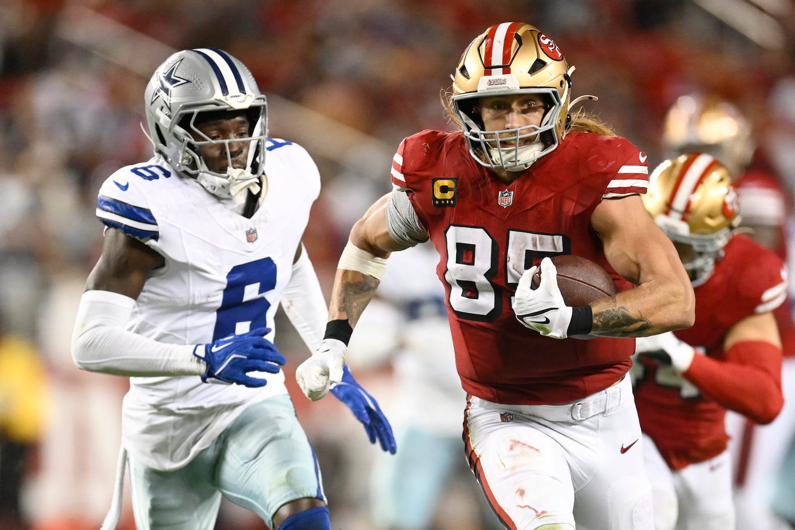 San Francisco 49ers tight end George Kittle (85) runs against Dallas Cowboys safety Donovan Wilson (6) during the second half of an NFL football game in Santa Clara, Calif., Sunday, Oct. 27, 2024. (AP Photo/Eakin Howard)