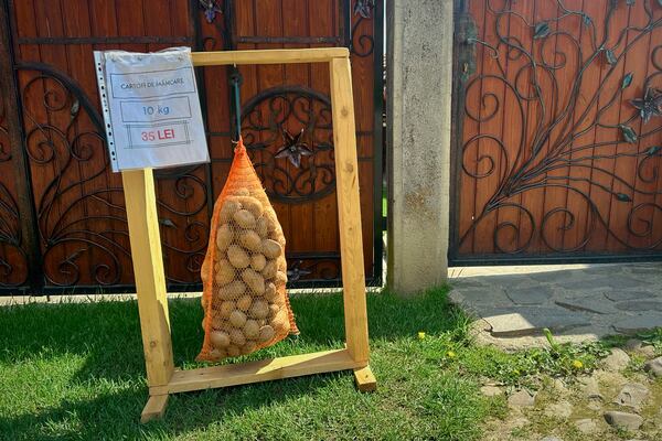 Potatoes on sale hang in a bag outside a house in the village of Saschiz, in Romania's central Transylvania region, Friday, April 25, 2025. (AP Photo/Stephen McGrath)