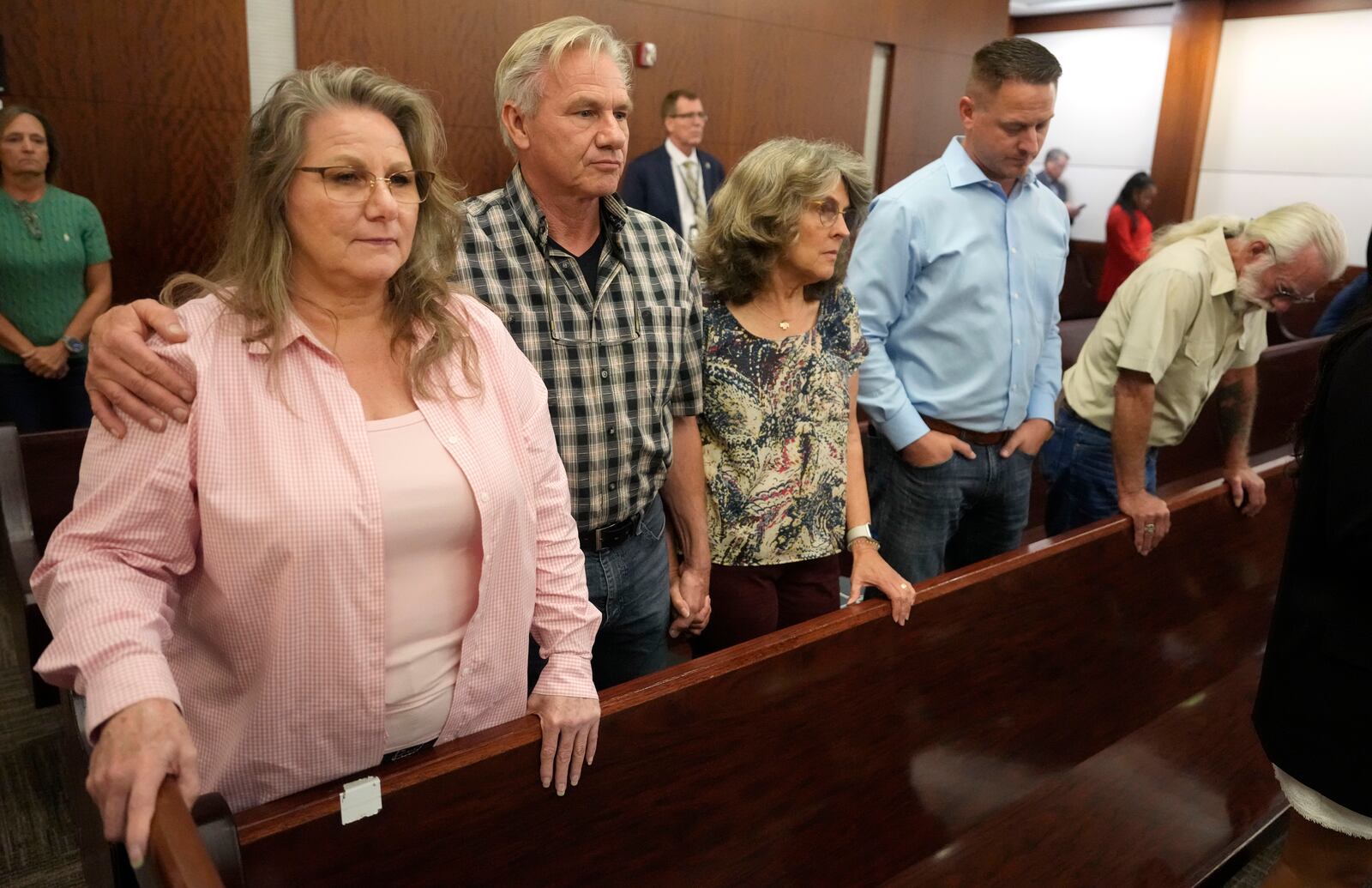 Family members of the late Dennis Tuttle wait for the jury to come into court for the verdict in murder trial of former Houston police officer Gerald Goines for the January 2019 deaths of Tuttle and Rhogena Nicholas, in the 482nd District Court at the Harris County Criminal courthouse Wednesday, Sept. 25, 2024, in Houston. Tuttle's siblings, from left, sister, Elizabeth Ferrari, and brother, Ron Tuttle, Ron's wife, Kristy Tuttle, Ryan Tuttle, son of Dennis Tuttle, and family friend Kenneth Ledbetter. (Melissa Phillip/Houston Chronicle via AP, Pool)