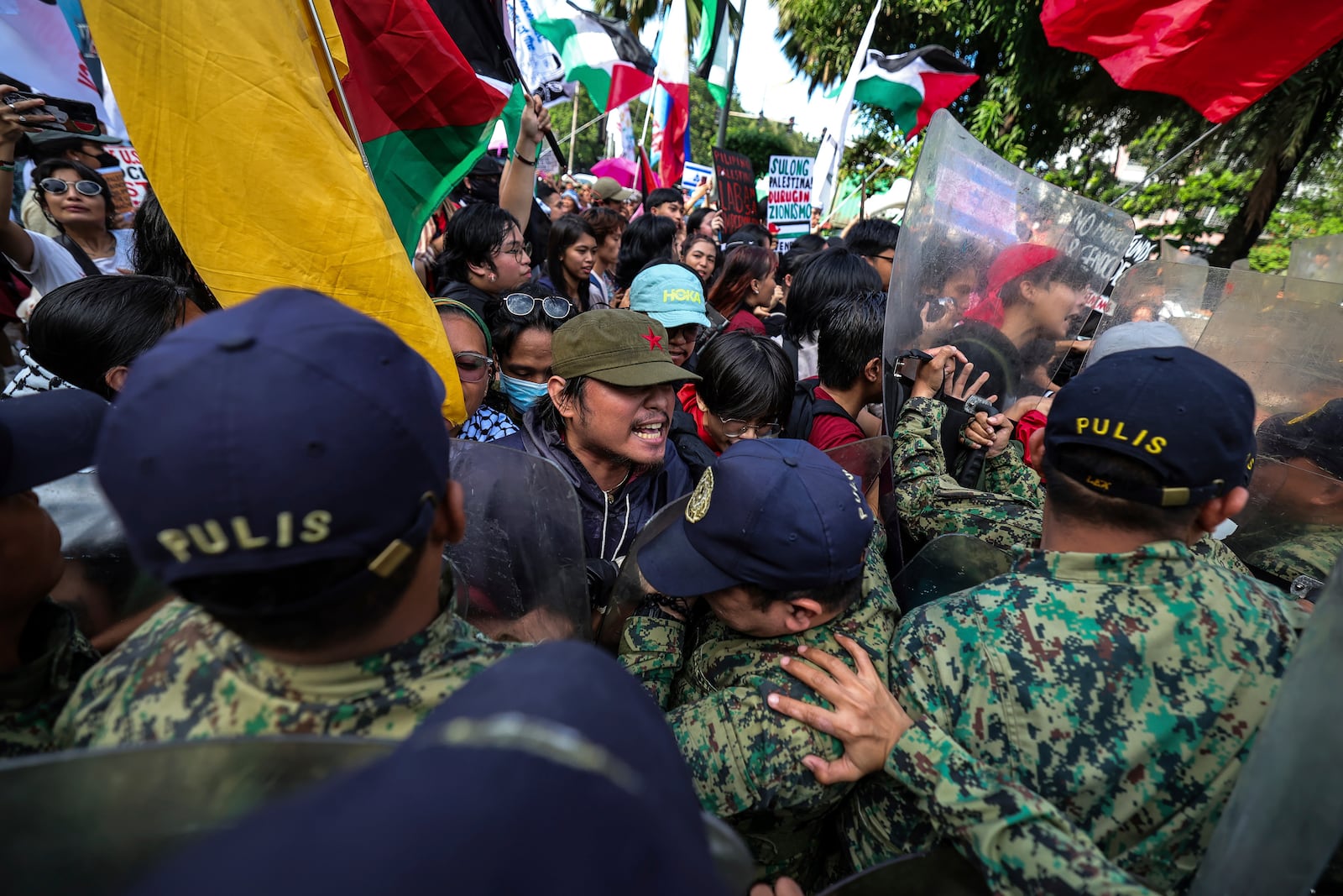 Police personnel block activists from marching near the U.S. Embassy in Manila Saturday, Oct. 5, 2024, as they hold a protest to observe the first-year anniversary of the war in Gaza. (AP Photo/Gerard V. Carreon)