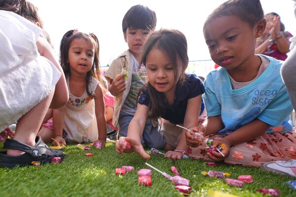 Children pick up candy during a Cinco de Mayo celebration at the Yorktown Spanish School in Dallas, Monday, May 5, 2025. (AP Photo/LM Otero)
