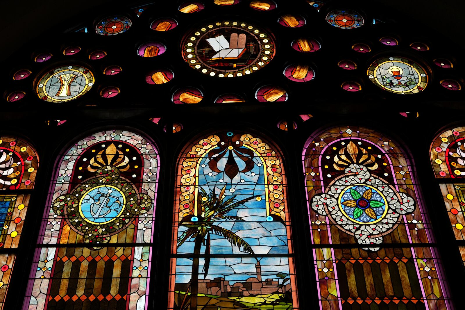 Sunlight shines through the colorful stained-glass windows at Philadelphia’s Mother Bethel AME on Sunday, Sept. 29, 2024. (AP Photo/Luis Andres Henao)