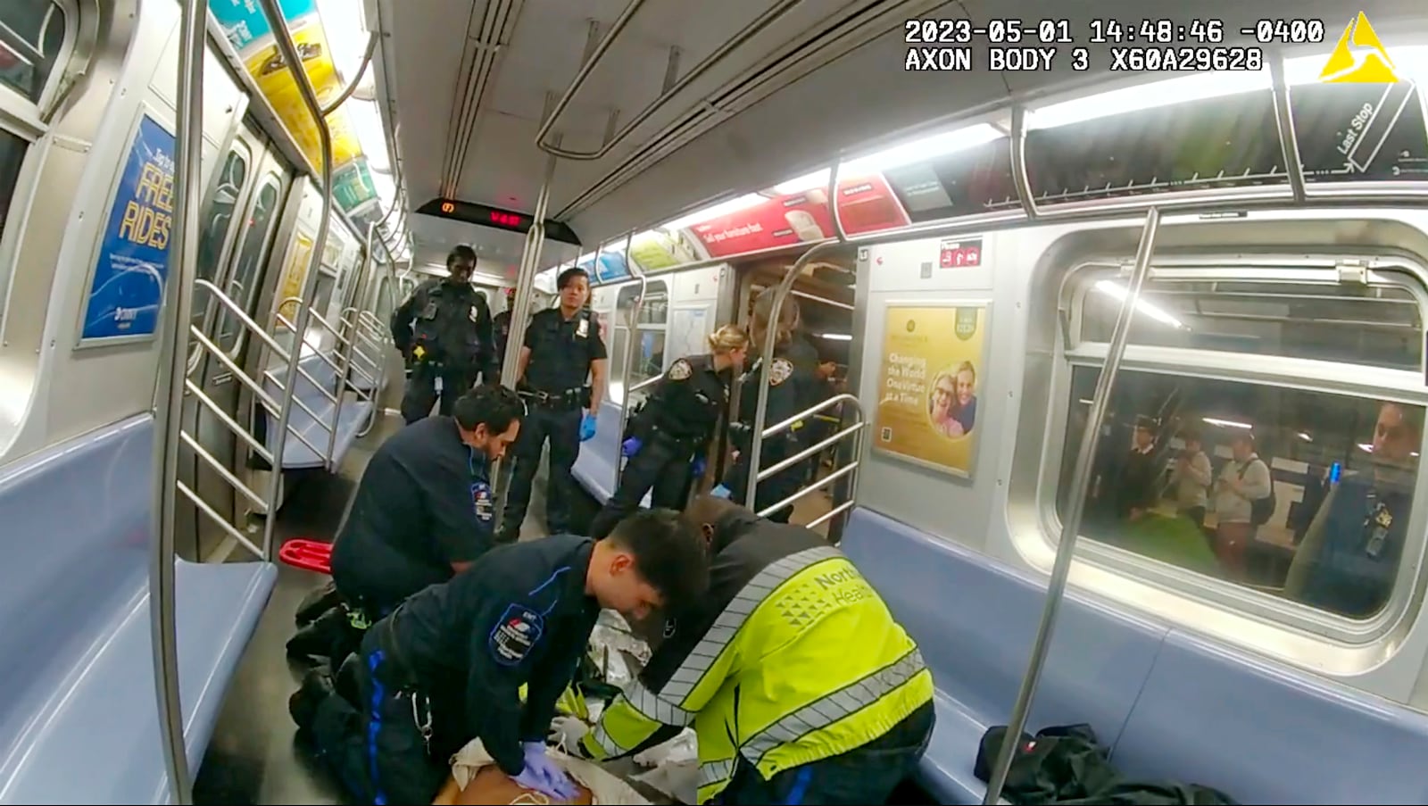 In this image from body camera video provided by New York City Police Department, emergency medical personnel in a New York City subway car attempt to revive Jordan Neely after he was placed in a chokehold by Daniel Penny on May 5, 2023. (New York City Police Department via AP)