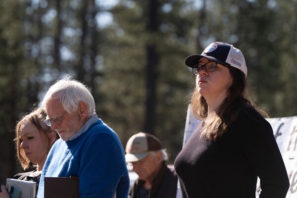 Jessica Gamble, who started the nonprofit Home More Network in 2022, right, looks on after reading text messages she received when a road to a homeless encampment in Deschutes National Forest was closed on Thursday, May 1, 2025, near Bend, Ore. (AP Photo/Jenny Kane)