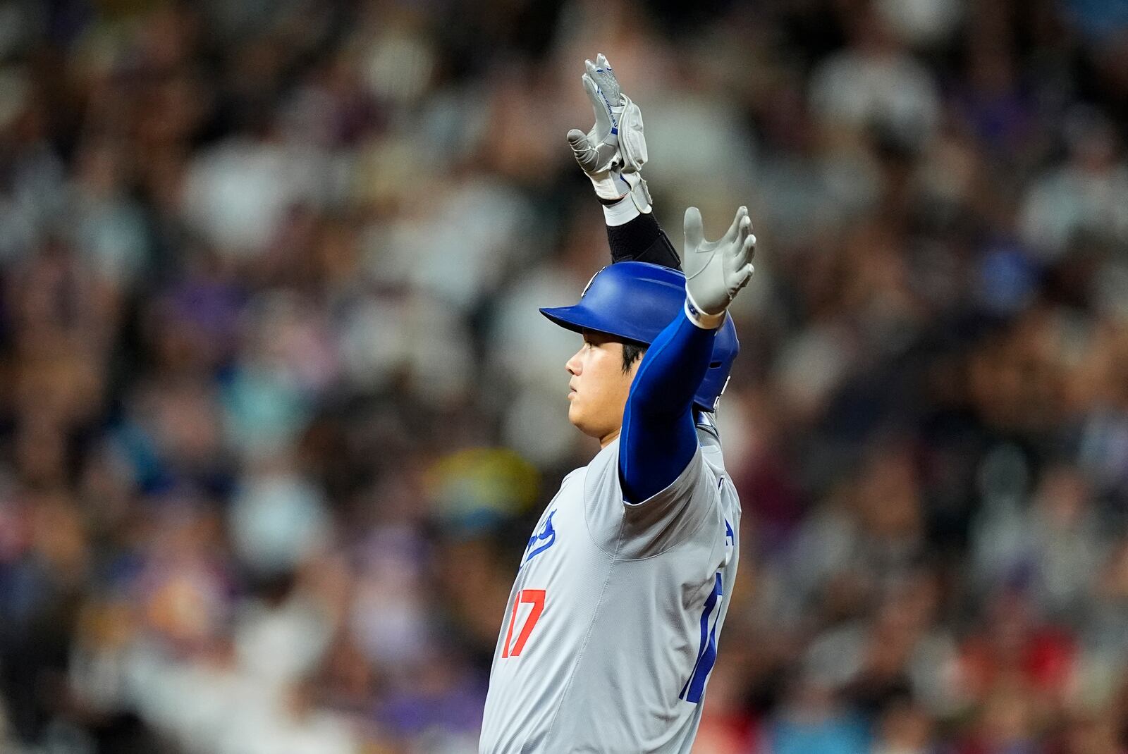 Los Angeles Dodgers' Shohei Ohtani gestures to the dugout after reaching second base on a double off Colorado Rockies relief pitcher Luis Peralta in the eighth inning of a baseball game, Friday, Sept. 27, 2024, in Denver. (AP Photo/David Zalubowski)