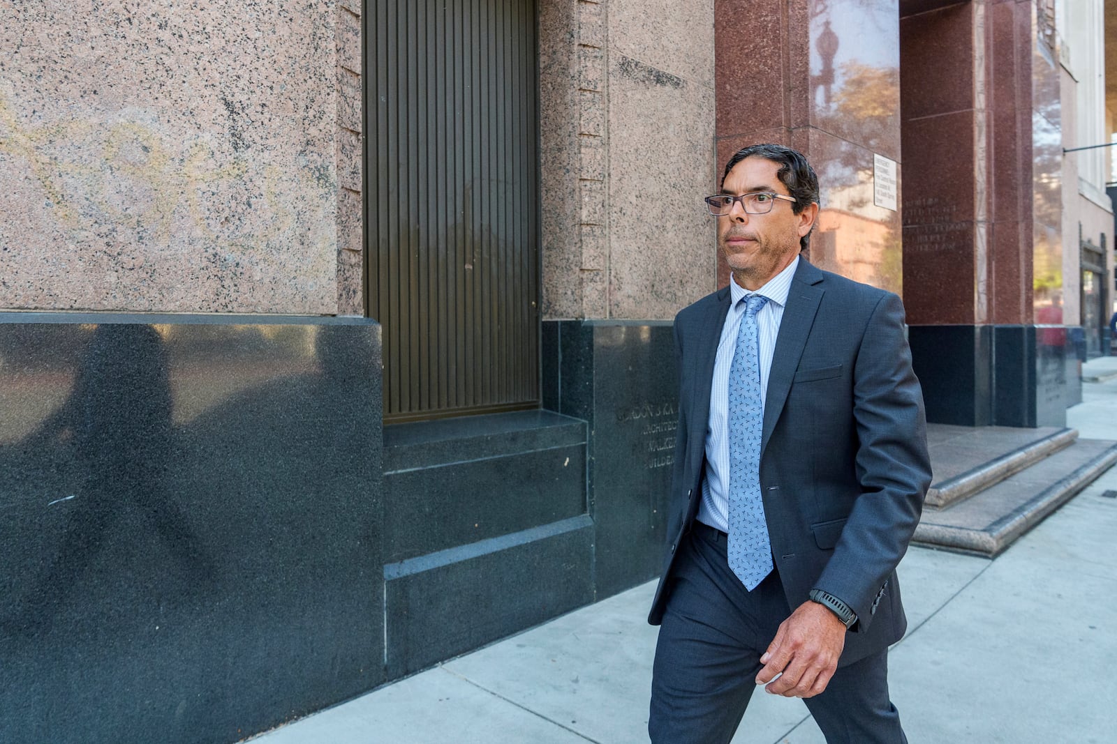 Dr. Mark Chavez, a physician from San Diego, who is charged in connection with Matthew Perry's fatal overdose, walks away from the media after pleading guilty in Los Angeles on Wednesday, Oct. 2, 2024. (AP Photo/Damian Dovarganes)