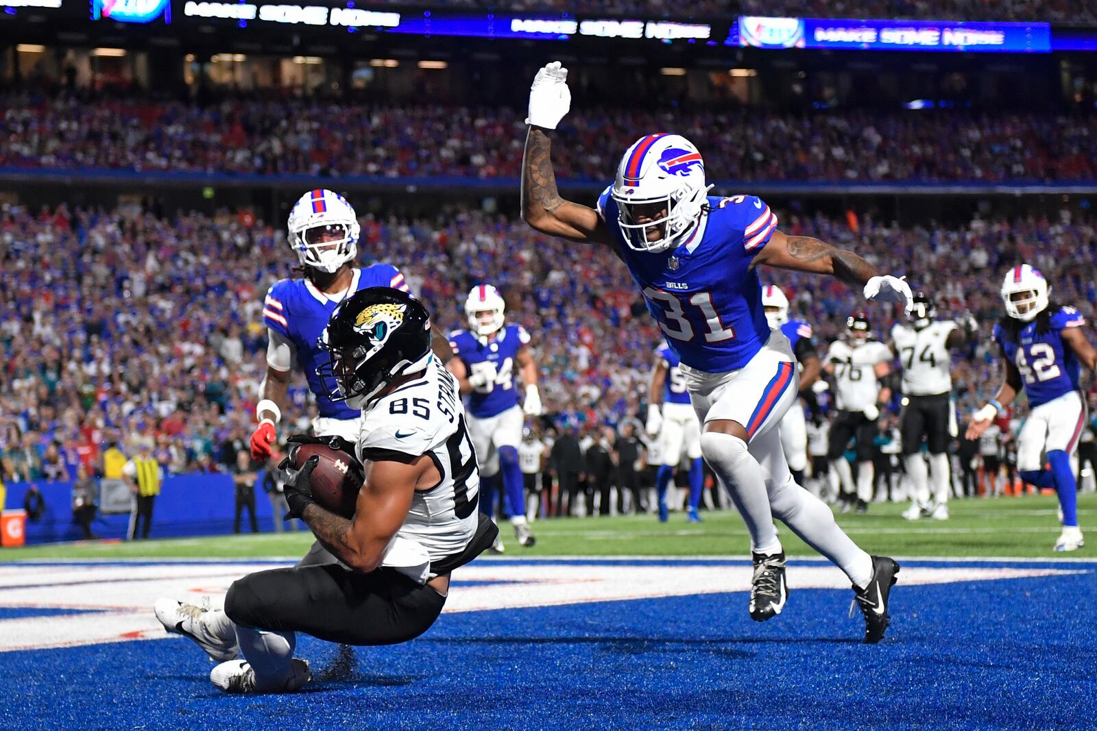 Jacksonville Jaguars tight end Brenton Strange (85) makes a touchdown catch past Buffalo Bills cornerback Rasul Douglas (31) during the second half of an NFL football game Monday, Sept. 23, 2024, in Orchard Park, NY. (AP Photo/Adrian Kraus)