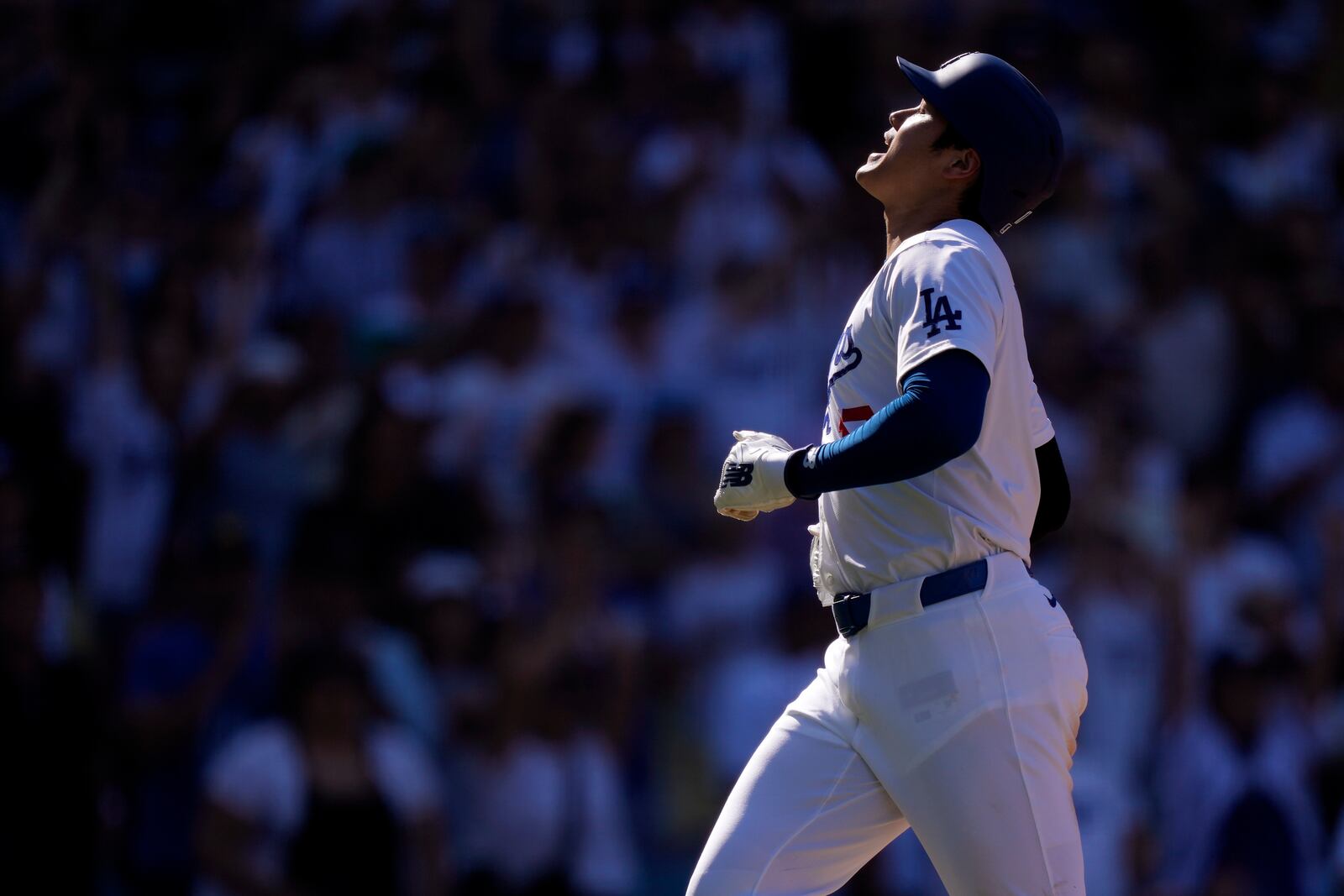 Los Angeles Dodgers' Shohei Ohtani scores on a single by Freddie Freeman during the seventh inning of a baseball game against the Colorado Rockies, Sunday, Sept. 22, 2024, in Los Angeles. (AP Photo/Mark J. Terrill)