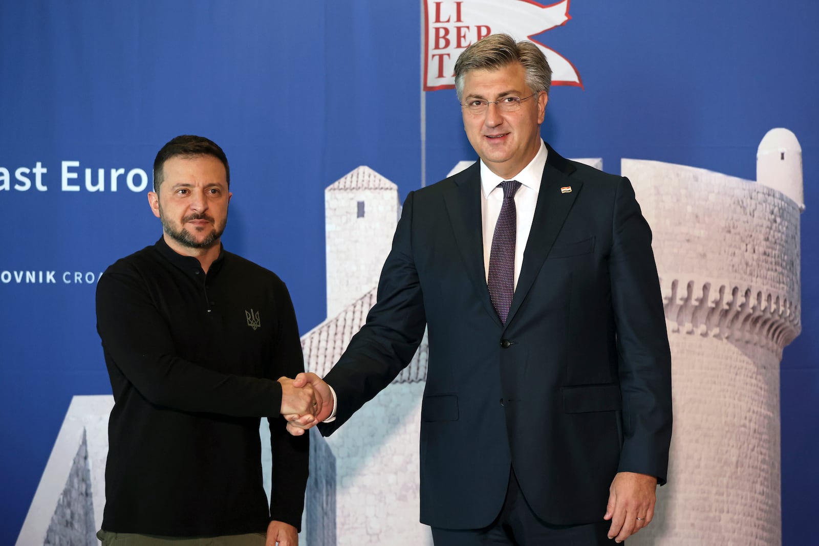 Ukrainian President Volodymyr Zelenskyy, left, is welcomed by Croatian Prime Minister Andrej Plenkovic at the Southeast Europe Croatia Ukraine summit in Dubrovnik, Croatia, Wednesday, Oct. 9, 2024. (Damir Sencar/Pool Photo via AP)