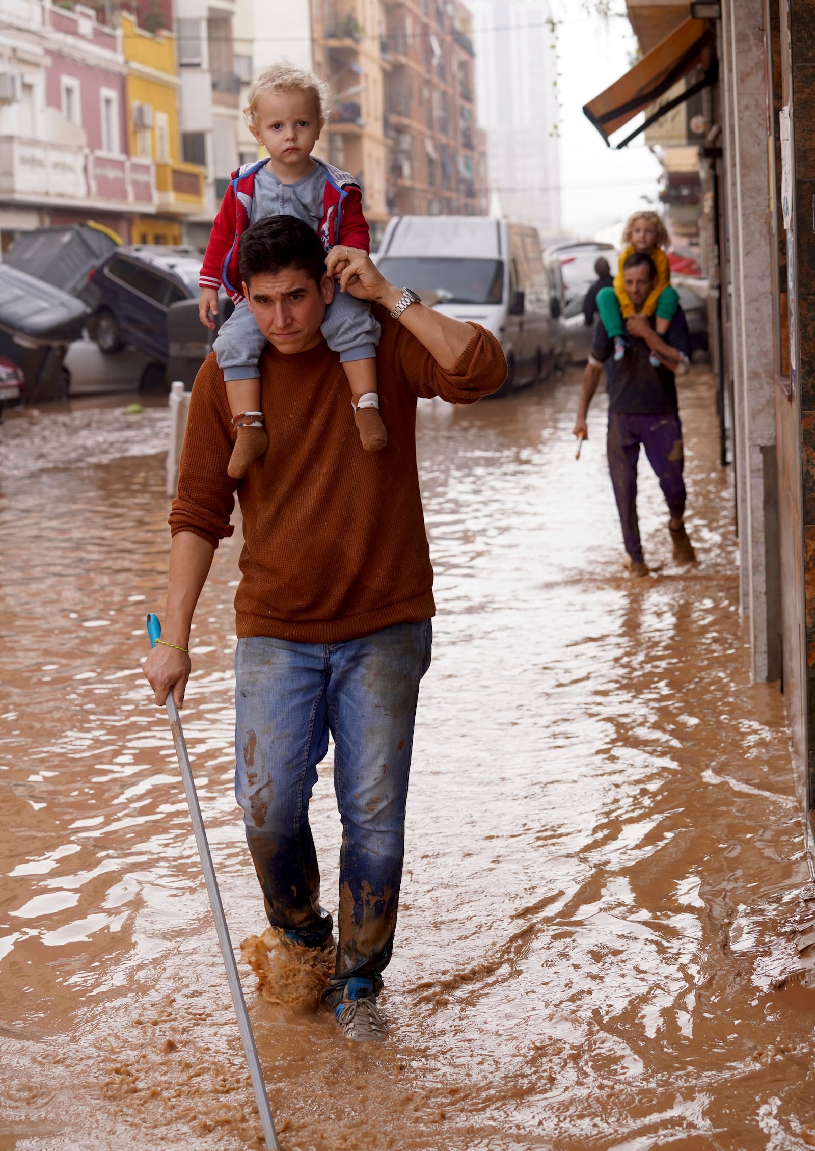 People walk through flooded streets in Valencia, Spain, Wednesday, Oct. 30, 2024. (AP Photo/Alberto Saiz)