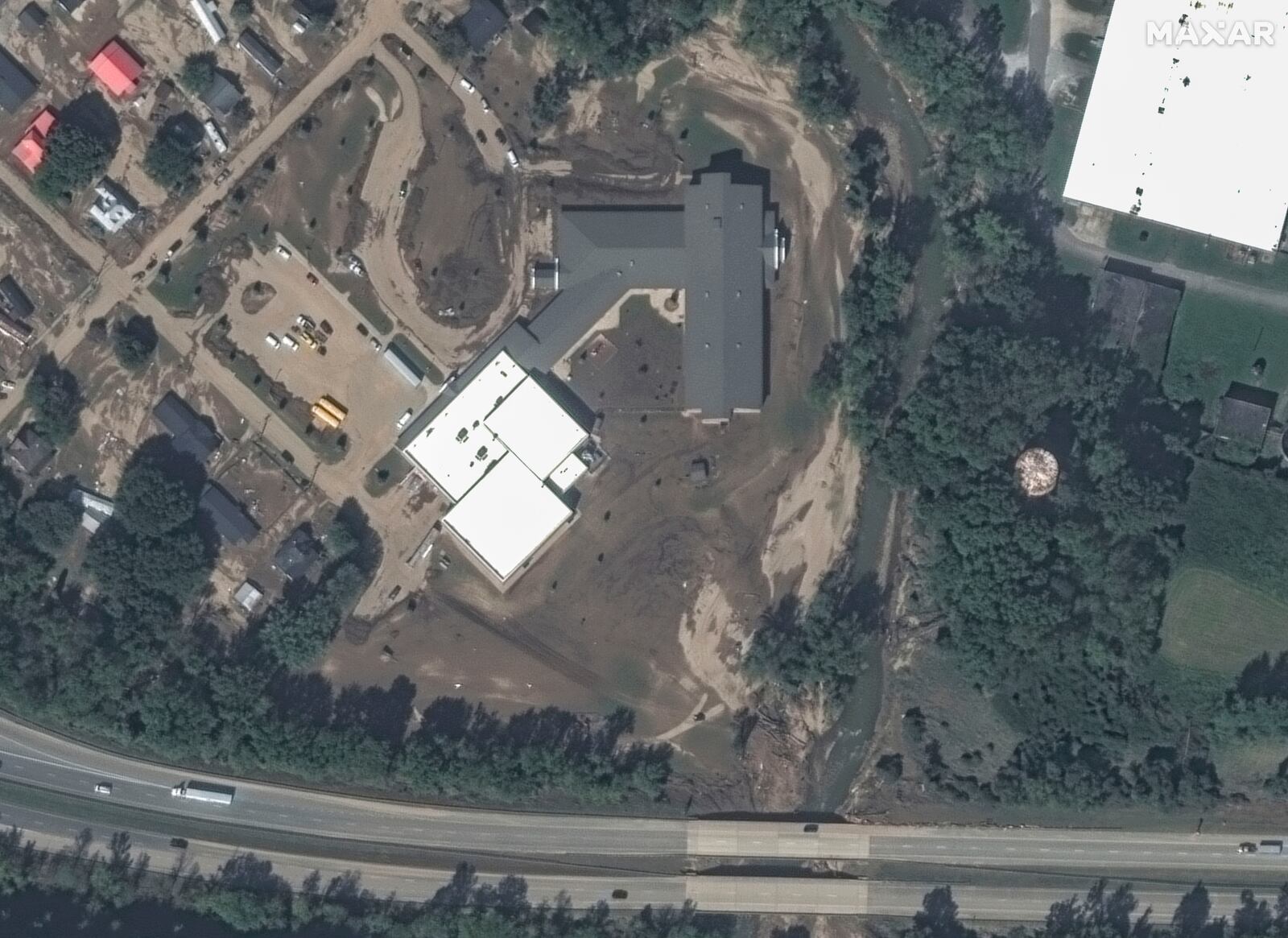 This satellite image released by Maxar Technologies shows mud and debris near Old Fort Elementary School, damage from Hurricane Helene in Old Fort, N.C., Wednesday, Oct. 2, 2024. (Satellite image ©2024 Maxar Technologies via AP)