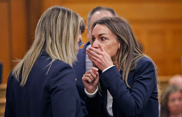 Karen Read, right, and lawyer Elizabeth Little discuss developments during Read's murder trial in Norfolk Superior Court in Dedham, Mass., Wednesday, May 21, 2025. (Greg Derr/The Patriot Ledger via AP, Pool)