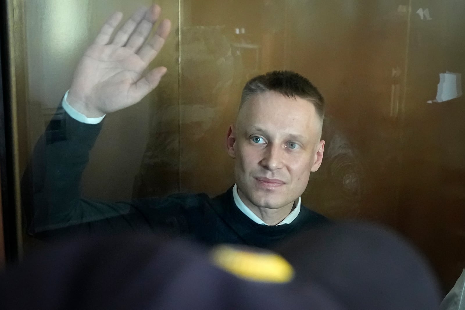 Russian journalist Konstantin Gabov accused of working for a group founded by the late Russian opposition politician Alexei Navalny, stands in a defendant's cage of the Nagatinsky District Court in Moscow, Russia, on Wednesday, Oct. 2, 2024. (AP Photo)