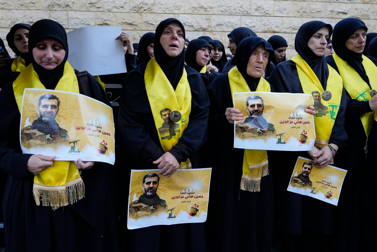 Mourners react as they attend the funeral procession of Hezbollah commanders Ibrahim Kobeisi and Hussein Ezzedine, pictured, in Beirut's southern suburb, Wednesday, Sept. 25, 2024. (AP Photo/Hassan Ammar)