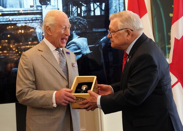 Britain's King Charles, left, is presented with the Key to Canada House by High Commissioner for Canada, Ralph Goodale, during a visit to Canada House to mark 100 years since it opened, at Trafalgar Square, in London, Tuesday May 20, 2025. (Arthur Edwards/Pool via AP)