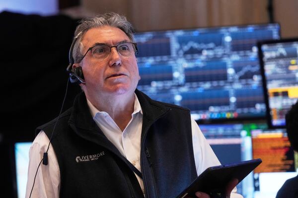 Trader John Bishop works on the floor of the New York Stock Exchange, Thursday, May 1, 2025. (AP Photo/Richard Drew)