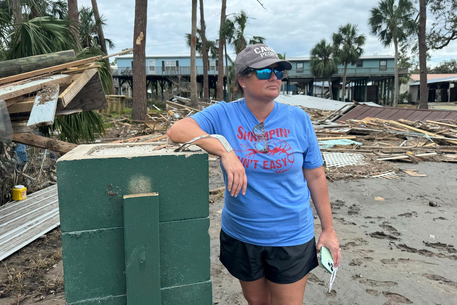 Brooke Hiers stands in front of where her home used to sit in Horseshoe Beach, Fla., Monday, Sept. 30, 2024, in the aftermath of Hurricane Helene. She and her husband had just rebuilt the home after Hurricane Idalia hit in August, 2023, before Hurricane Helene blew the house off its pilings and floated it into the neighbor's yard next door. (AP Photo/Kate Payne)