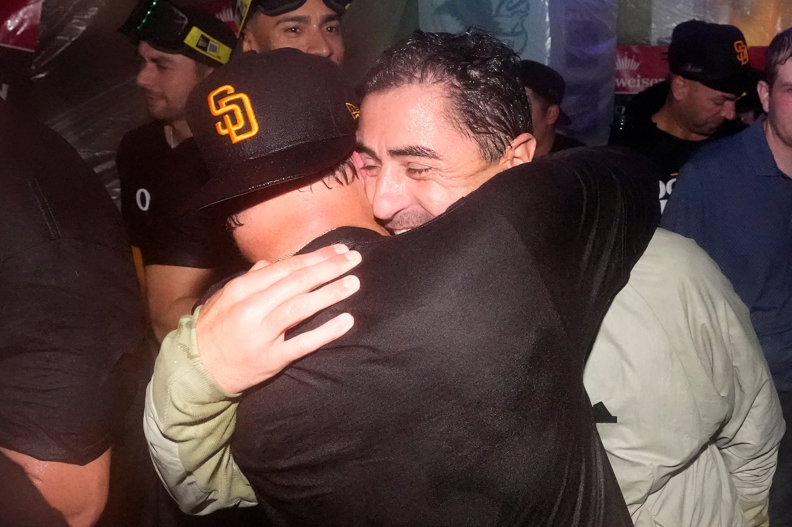 San Diego Padres manager Mike Shildt, left, celebrates with general manager A.J. Preller after the Padres clinched a playoff spot with a triple play to end their baseball game against the Los Angeles Dodgers, Tuesday, Sept. 24, 2024, in Los Angeles. (AP Photo/Mark J. Terrill)