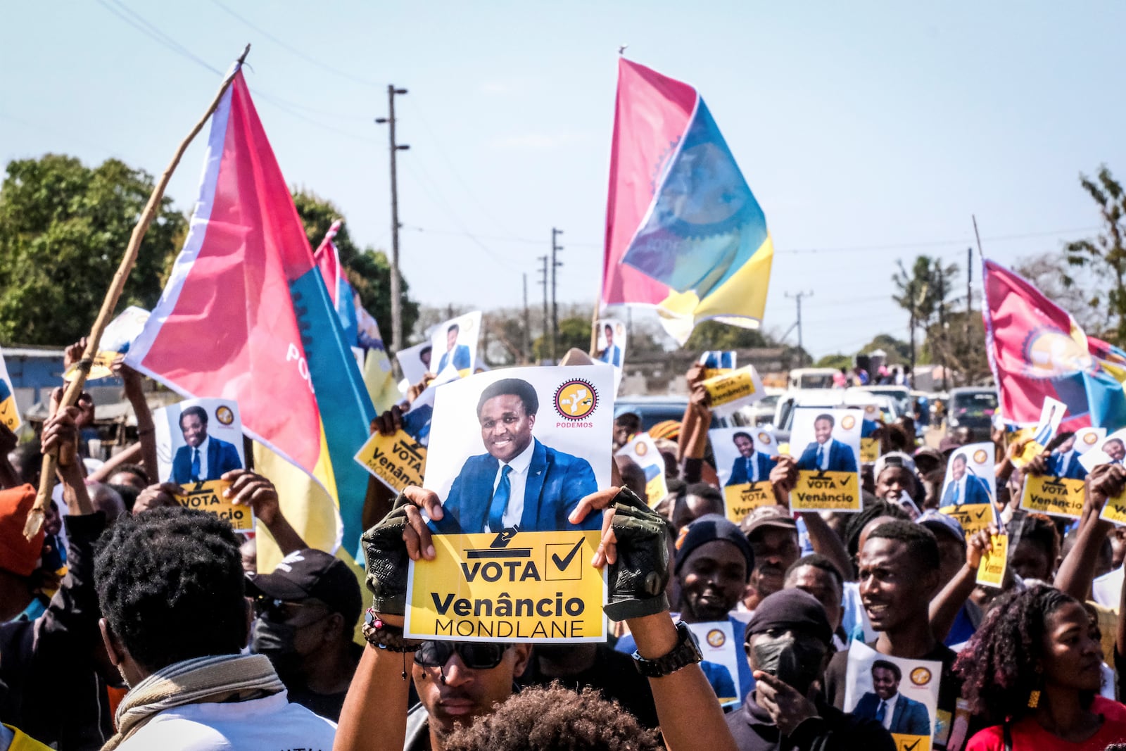 A poster of independent candidate Venacio Mondlane is held at an election rally on Sunday, Oct. 6, 2024 in Maputo ahead of elections in Mozambique. (AP Photo/Carlos Uqueio)