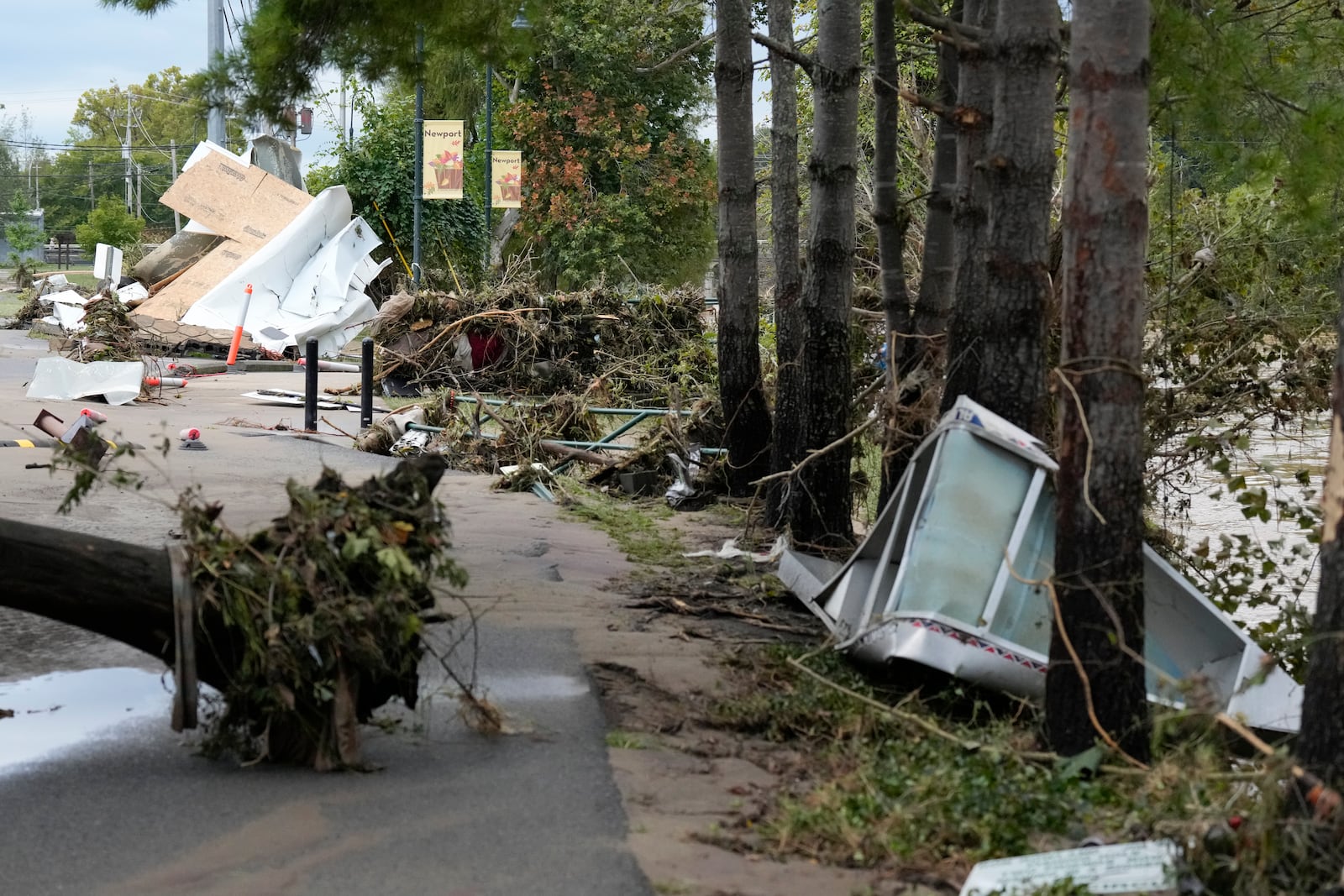 Flood debris along the Pigeon river left by tropical depression Helene is seen in Newport, Tenn., Saturday, Sept. 28, 2024. (AP Photo/George Walker IV)