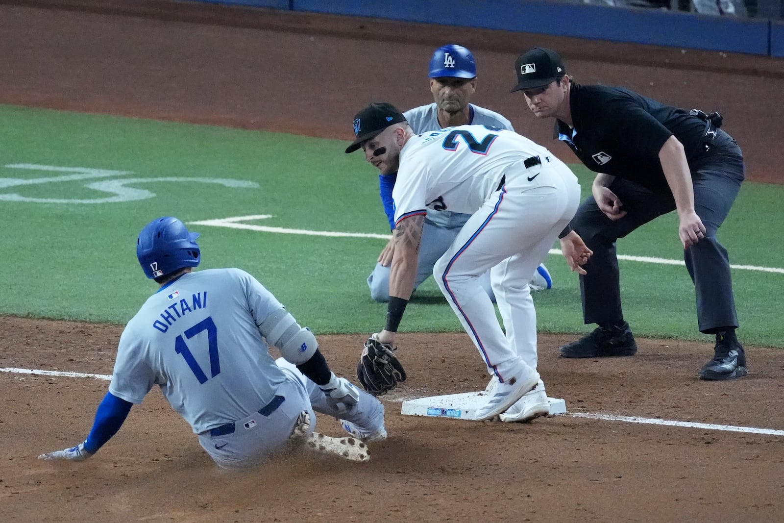 Miami Marlins third baseman Connor Norby tags out Los Angeles Dodgers' Shohei Ohtani (17) of Japan, after Ohtani attempted to stretch out a double during the third inning of a baseball game, Thursday, Sept. 19, 2024, in Miami. (AP Photo/Wilfredo Lee)