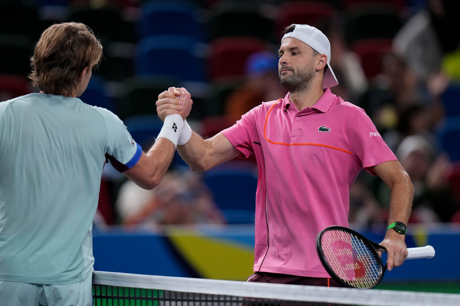 Grigor Dimitrov of Bulgaria, right, is congratulated by Zizou Bergs of Belgium after winning in the men's singles second round match in the Shanghai Masters tennis tournament at Qizhong Forest Sports City Tennis Center in Shanghai, China, Monday, Oct. 7, 2024. (AP Photo/Andy Wong)